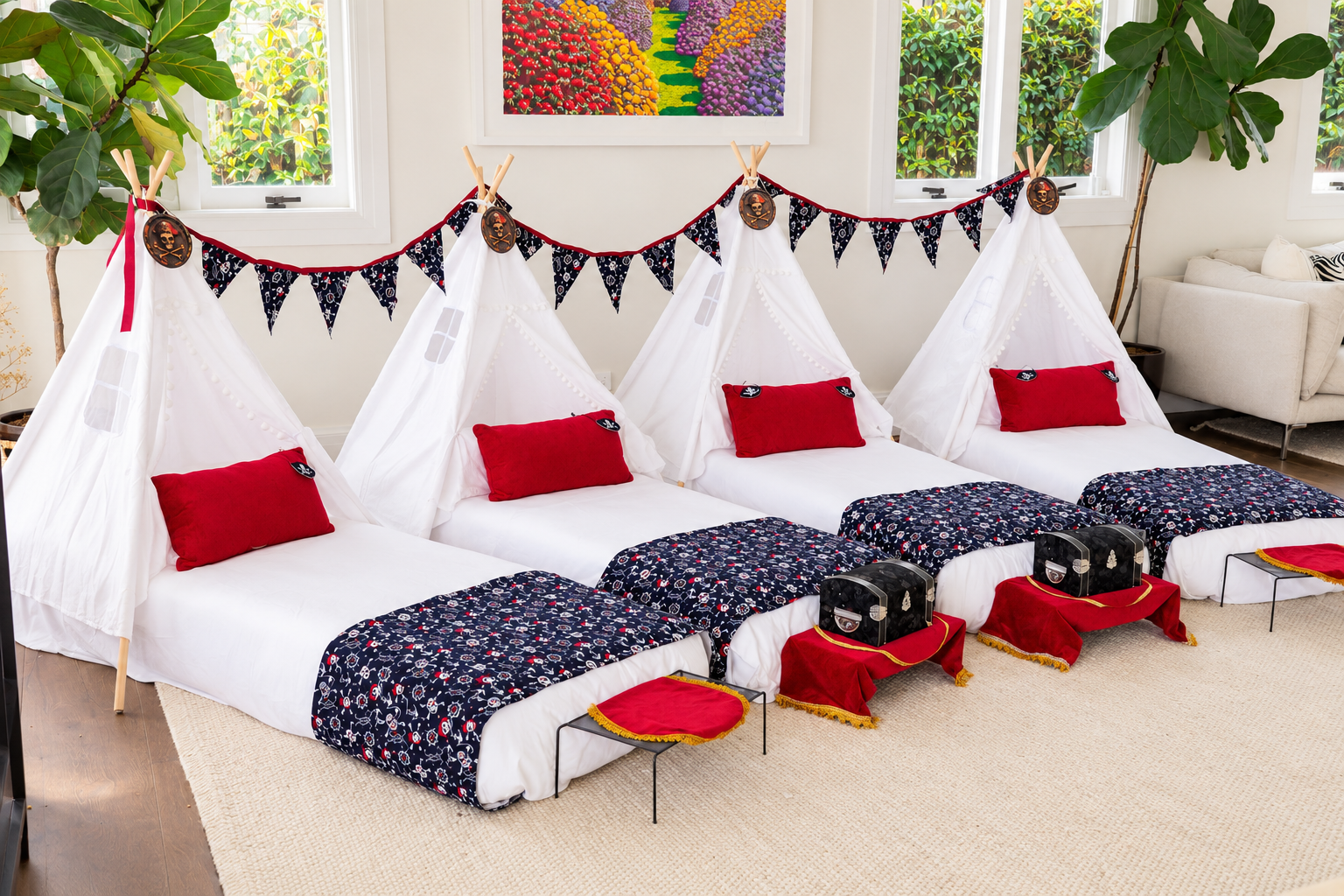 Pirate teepee sleepover with pirate bunting, red pillows, eye patches and a treasure chest